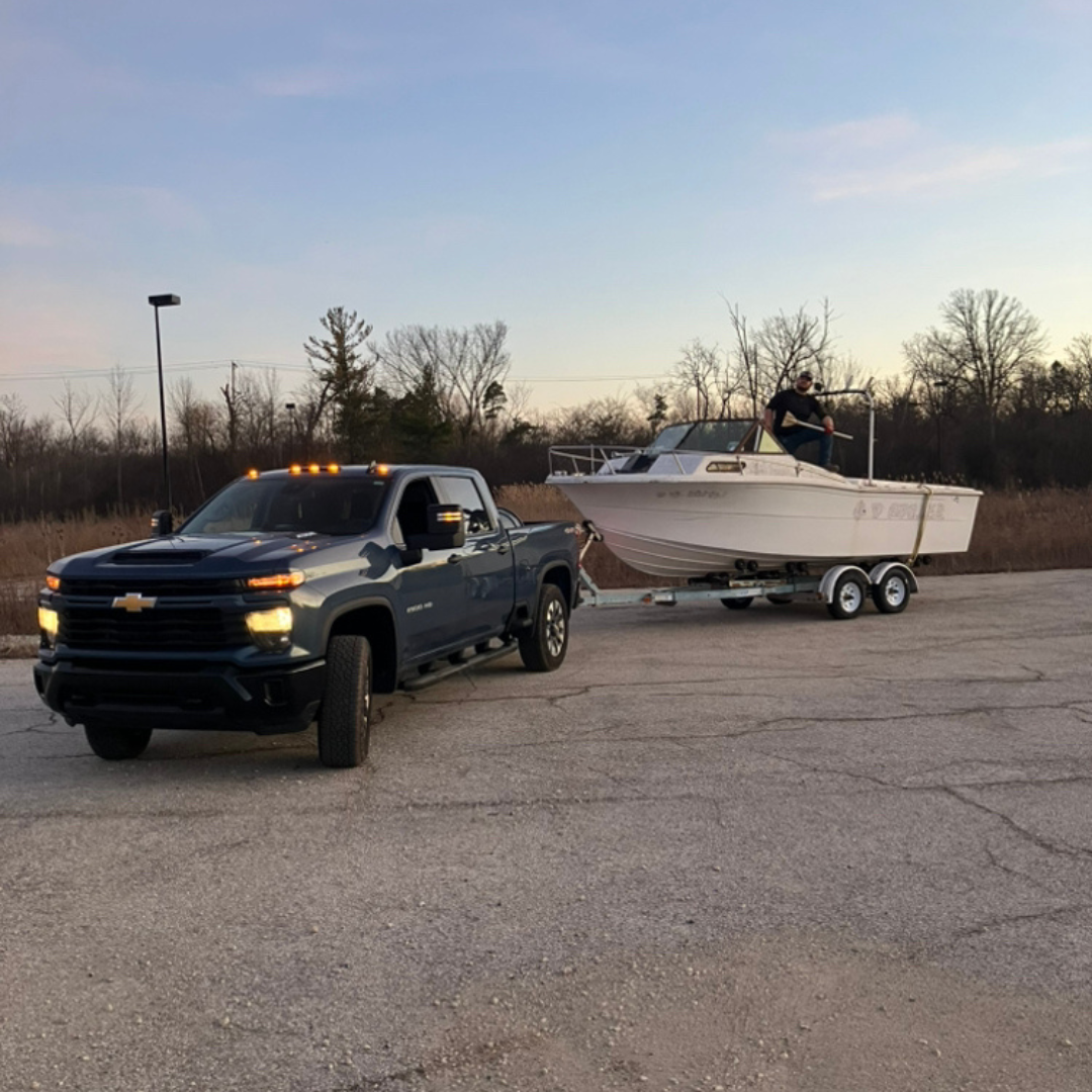 Patriot Clean Out hauling an old boat from a commercial property in Northwest Indiana with a pickup truck.
