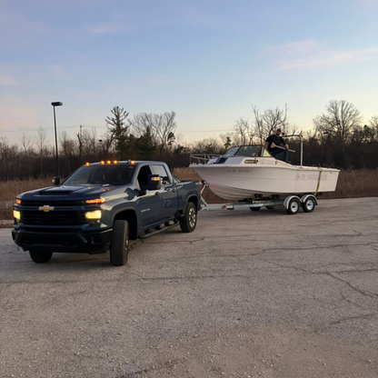 Patriot Clean Out hauling an old boat from a commercial property in Northwest Indiana with a pickup truck.