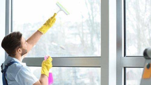 Patriot Clean Out technician providing commercial window cleaning services for businesses in Northwest Indiana using professional-grade equipment.