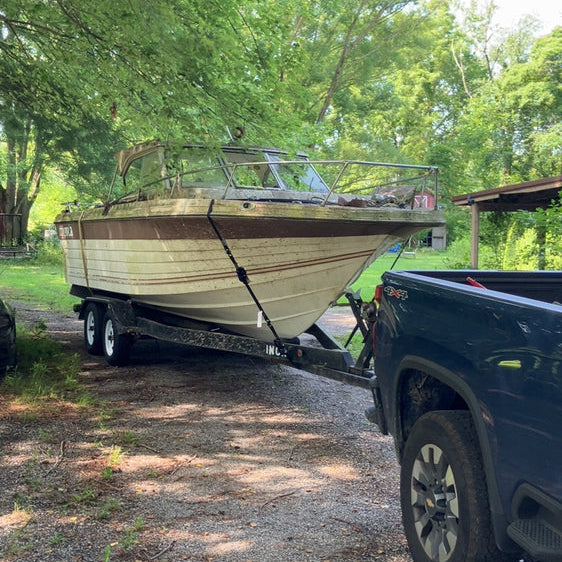 Patriot Clean Out crew hauling away an old boat from a Northwest Indiana property, representing fast and eco-friendly boat removal services by a veteran-owned team.