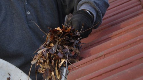 Patriot Clean out technician downspout cleaning and leaf removal of NWI home