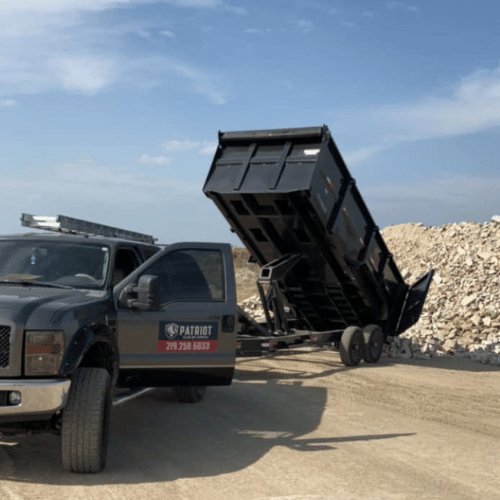 A Patriot Clean Out dump truck unloading demolition debris at a designated disposal site in Lake County, Indiana. We ensure eco-friendly waste removal for your commercial projects.